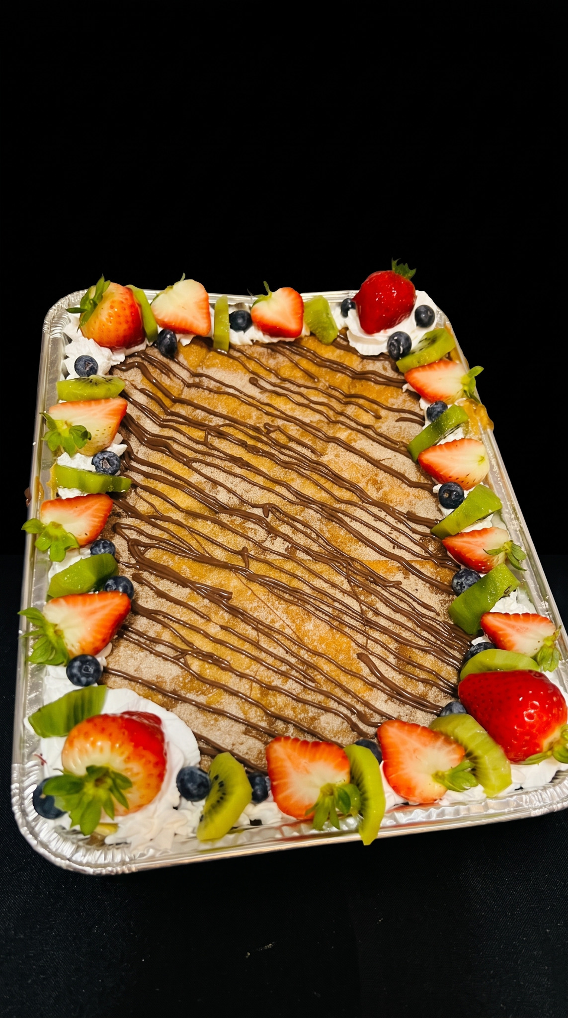 A tray of fruit and desserts arranged for sharing